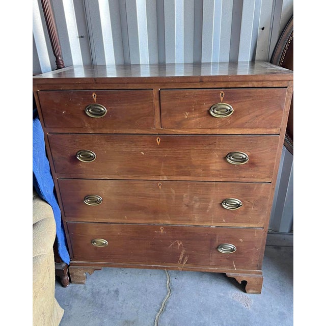 Traditional Georgian-style chest featuring two smaller upper drawers over three full-width drawers, oval metal bail pulls,...