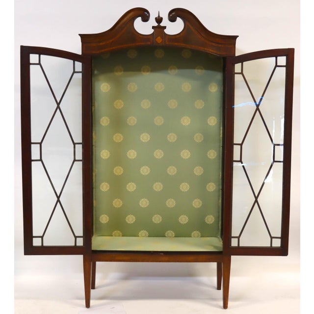 A refined English mahogany display cabinet, dating to the second quarter of the 19th century and executed in the Edwardian...