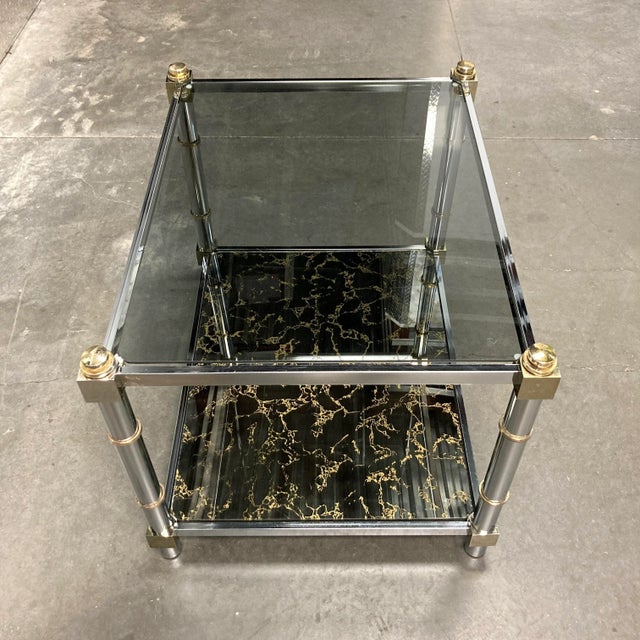 French Jansen design tiered end table in chrome, brass, smoked glass, and acid drip bronze mirrored lower, mirror back...