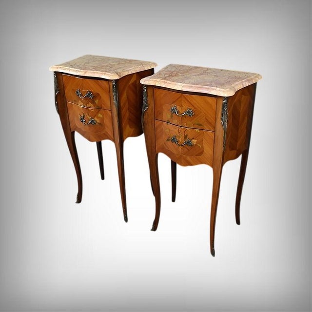 These two marquetry bedside tables feature a curved line typical of the Louis XV style, with harmonious curves and a...