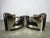 An impressive pair of Timothy Oulton Aviator armchairs, expertly combining polished and brushed steel with premium black...