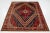 This vintage Shiraz has a red field with multicolor accents all over the geometric motif. This rug measures 6'8'' x 9'10''.