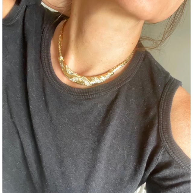 Chic 1980s Christian Dior choker necklace with gold link sides and curved, crystal embellished pendant at front. Slightly...