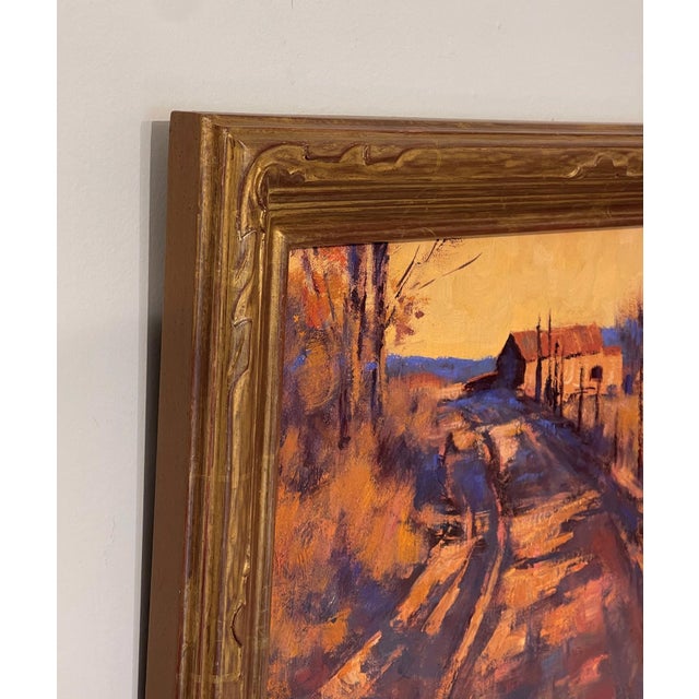 This oil painting captures a serene rural landscape bathed in warm, golden hues as the sun sets, casting long shadows...