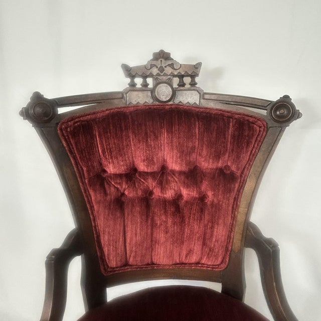This listing is for an antique Victorian-style parlor chair featuring rich red velvet tufted upholstery and classic turned...
