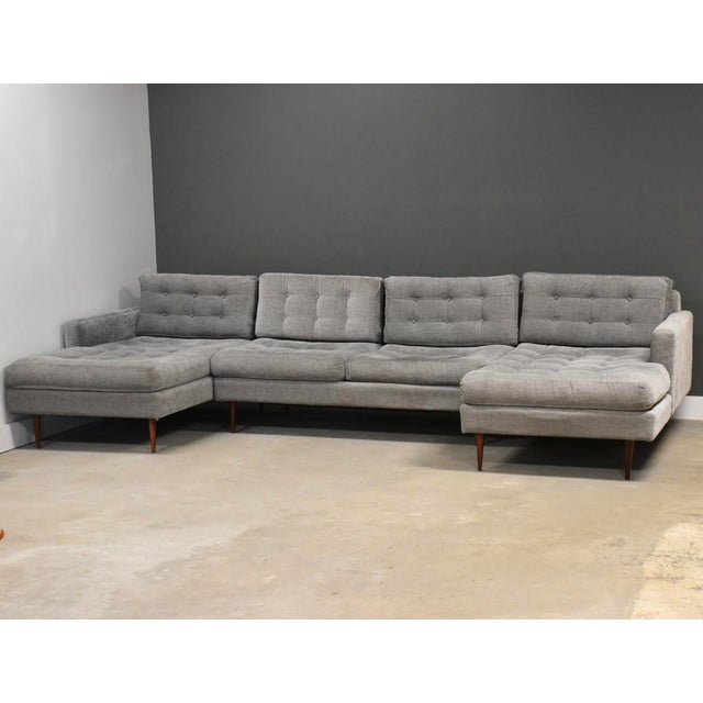 A three section U shaped modular grey sofa with mid century modern lines and walnut color legs. All around excellent...