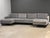 A three section U shaped modular grey sofa with mid century modern lines and walnut color legs. All around excellent...