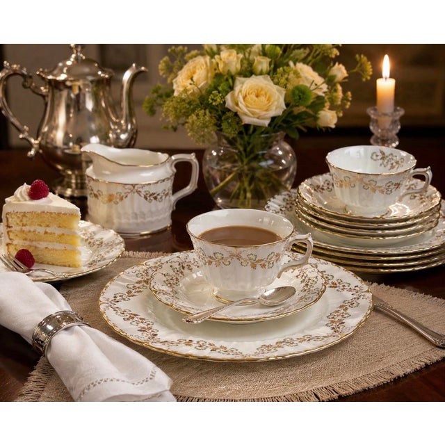 A beautifully preserved Royal Crown Derby “Touraine” English bone china tea service for six, decorated with elegant green...