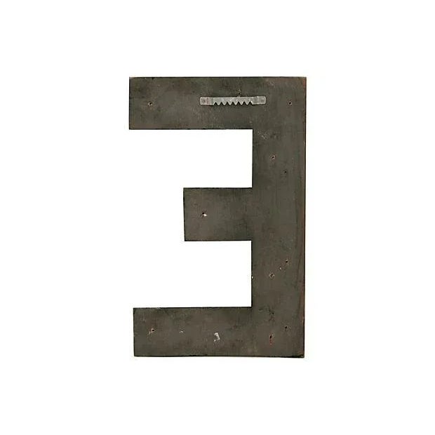Vintage wood handmade sign letter E in original black paint. Hanger on back. Wear, scratches, chips, holes where once...