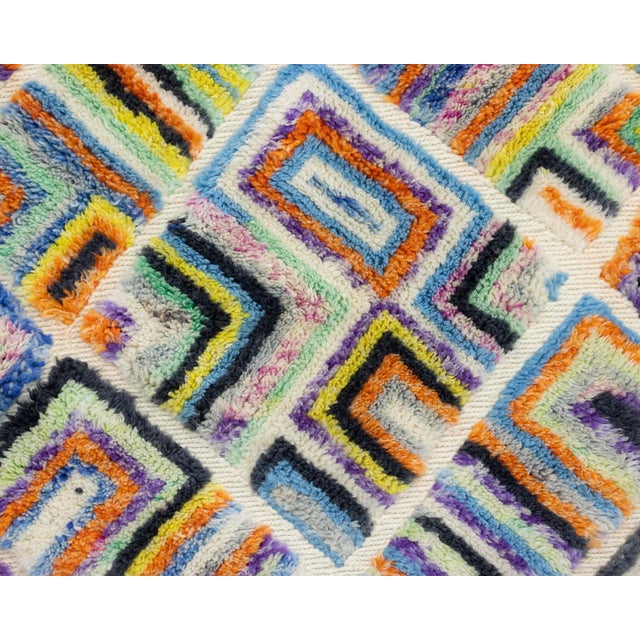 A joyful explosion of color, woven into an intricate maze. This hand-knotted wool runner bursts with a kaleidoscopic...