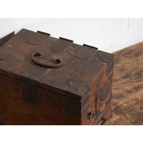 This antique japanese document chest with drawers, a portable tansu, is crafted in solid wood with extensive hand-forged...