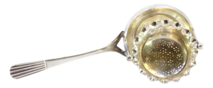 Silver Tea Strainer with Embossed Cup-Shaped Deposit and Reed-Style Handle