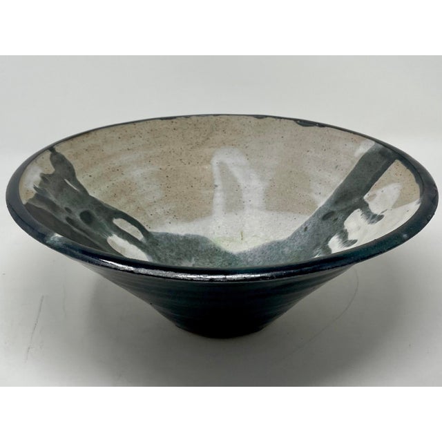 Vintage 1980s abstract studio pottery bowl, black and white glaze on gray-taupe clay. Dimensions: 9.75"diameter x 4"high.