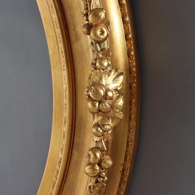 This elegant oversized antique Victorian gilt wood oval frame, dating from circa 1890, exemplifies the decorative grandeur...