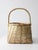 Vintage handmade basket with a softly tapered form and an arched handle. The open, rhythmic weave reveals layered tones of...