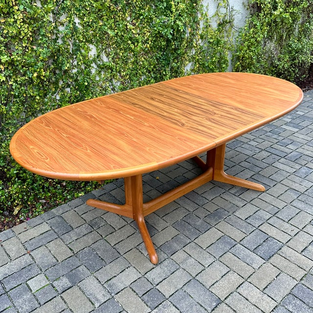 Scandinavian mid century modern teak dining table on trestle base with internal leaf storage, made in Denmark by Skovby c....