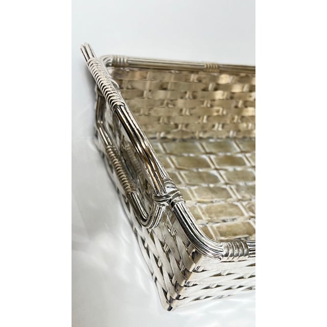 Vintage early 20th century French woven silver rectangular basket featuring reeded handles and edge trim. This piece is...
