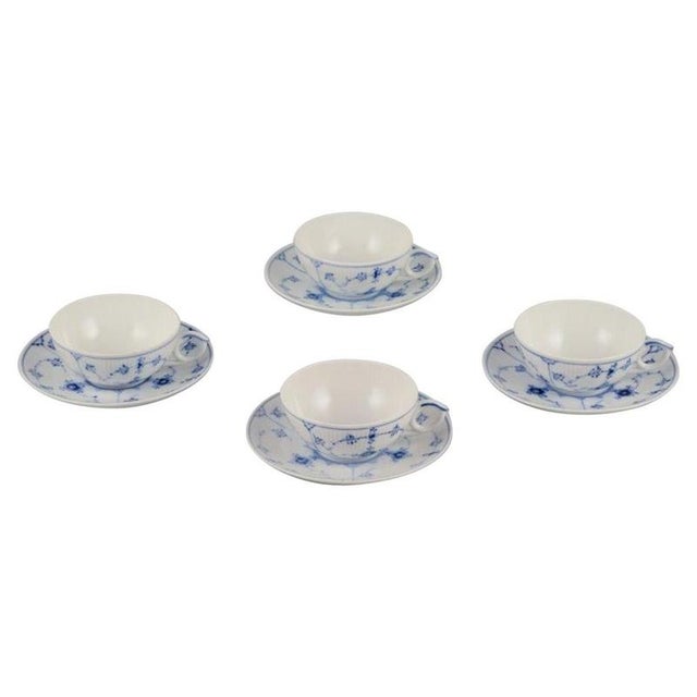 Royal Copenhagen Blue Fluted Plain. A set of four porcelain teacups with saucers. Model 1/76. Dating: Approximately 1950....