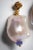A pair of baroque pearl earrings with a faceted tanzanite gemstone bead at the bottom and 22K gold post and beads. For...