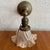 Dating from the early 20th century, this early industrial wall sconce pairs a solid brass pipe arm with an elegant ruffled...
