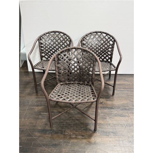 Design Plus Gallery presents a Set of Three Vintage Outdoor Armchairs from Brown Jordan. Woven resin straps create an open...