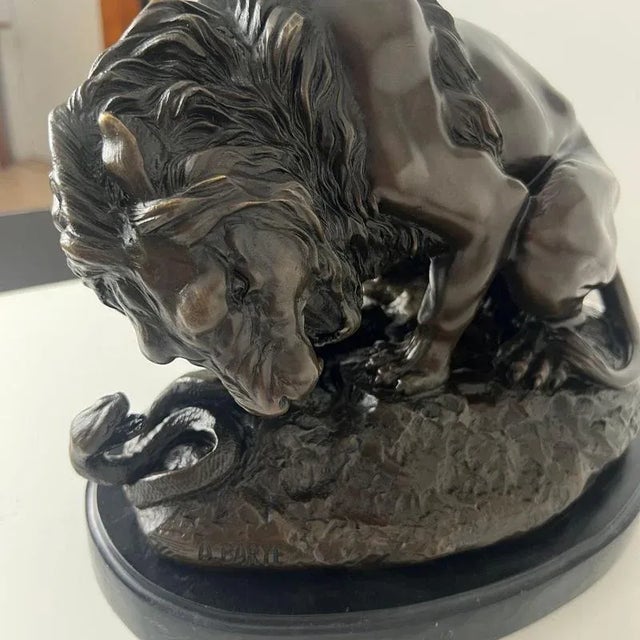 Solid bronze figure of a lion fighting a snake, a famous motif by a. Barye. Engraved on the plinth “a. Barye” (antoine-...