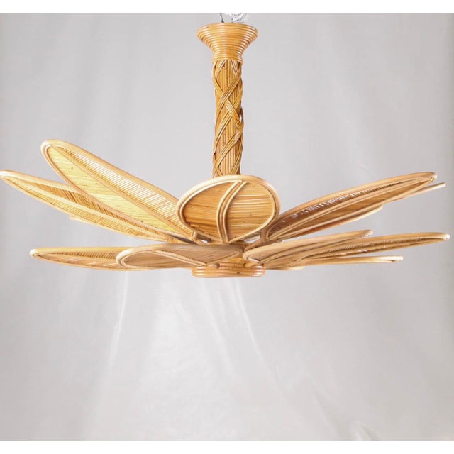 Incredible rattan chandelier composed of a central trunk with interwoven rattan and numerous leaves that attach to the...