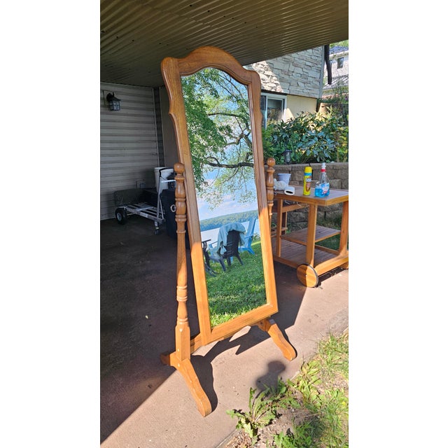 Bring a touch of timeless American craftsmanship into your space with this classic vintage cheval floor mirror by Ethan...