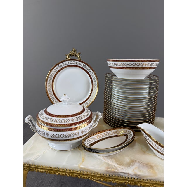 An elegant limoges porcelain dinner service, signed leclaire limoges france, featuring a refined classic design in...