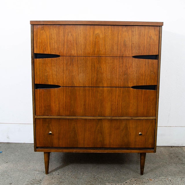 Walnut highboy dresser with 4 drawers. Has a laminate top surface for easy cleaning. Includes brass drawer pulls and black...