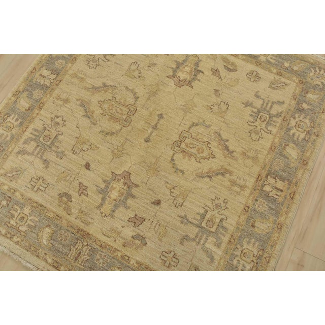 A traditional Ziegler rug hand-knotted with fine wool on a cotton foundation. This rug features a subtle botanical design...