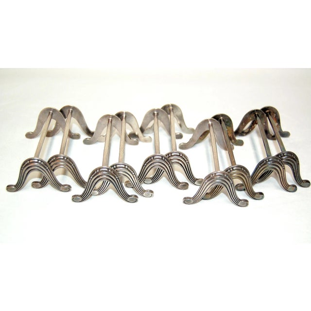 This set consists of 11 silver plated knife holders from around 1925.