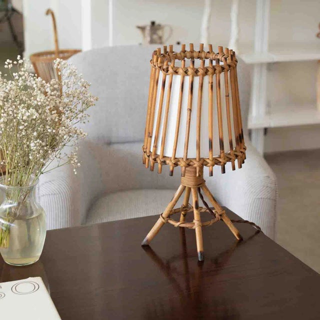 Great vintage rattan lamp from France, 1960s. Rattan four leg base with rattan tapered shade and interior silk diffuser....