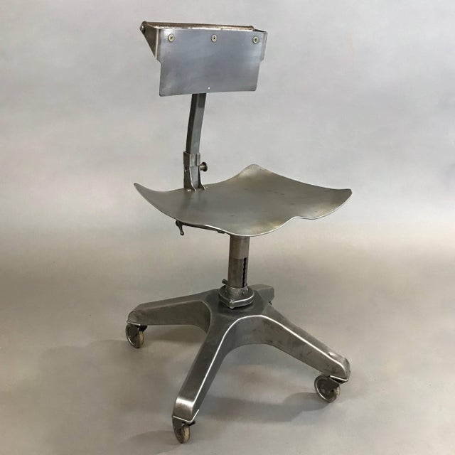 Industrial, brushed heavy gauge steel, adjustable posture office chair or stool designed by Ernest Bacz and manufactured...