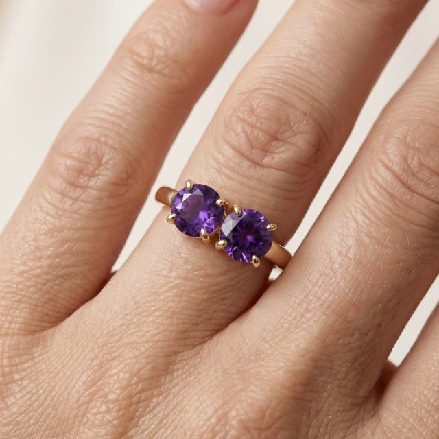 Celebrate love, friendship, or a beautiful milestone with this elegant 18k gold-plated two-stone ring. Featuring a pair of...