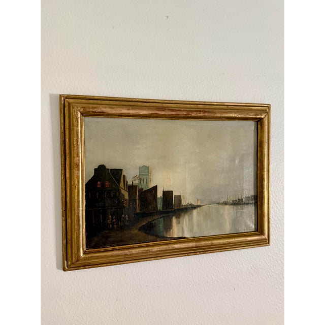 Discovered in Paris and signed by the artist, this antique painting is oil on canvas depicting a Dutch waterfront setting...