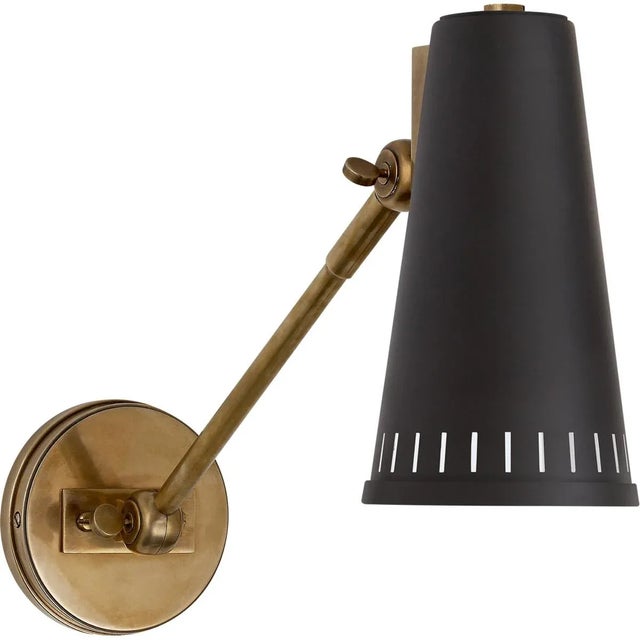 Antonio Adjustable One Arm Wall Lamp in Hand-Rubbed Antique Brass with Matte Black Shade Designer: Thomas O'Brien Height:...