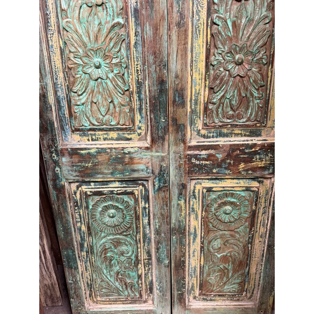 Six hand-carved panels, each blooming with floral and leaf motifs, layered over reclaimed wood that wears its age with...