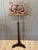 A mid-19th C American mahogany and brass duet stand, the double-sided rests of lyre form with carved facing C-scrolls and...