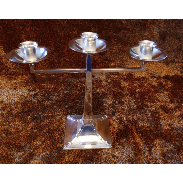 A pair of James Dixon & Sons three-branch silver plated Arts & Crafts candelabra This is a magnificent pair of early 20th...