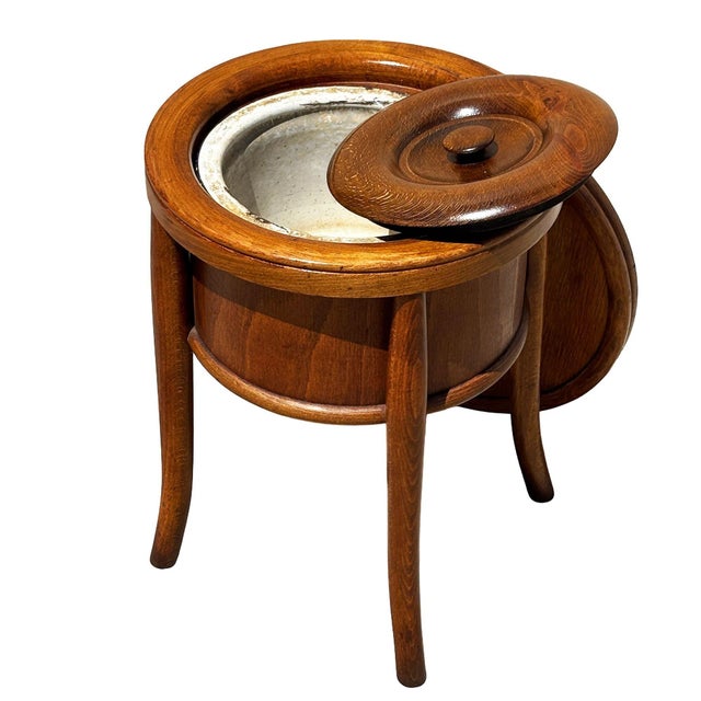 Late Victorian sculpted walnut chamber pot with original lid and enameled metal bowl by Thonet featuring an sculptural...