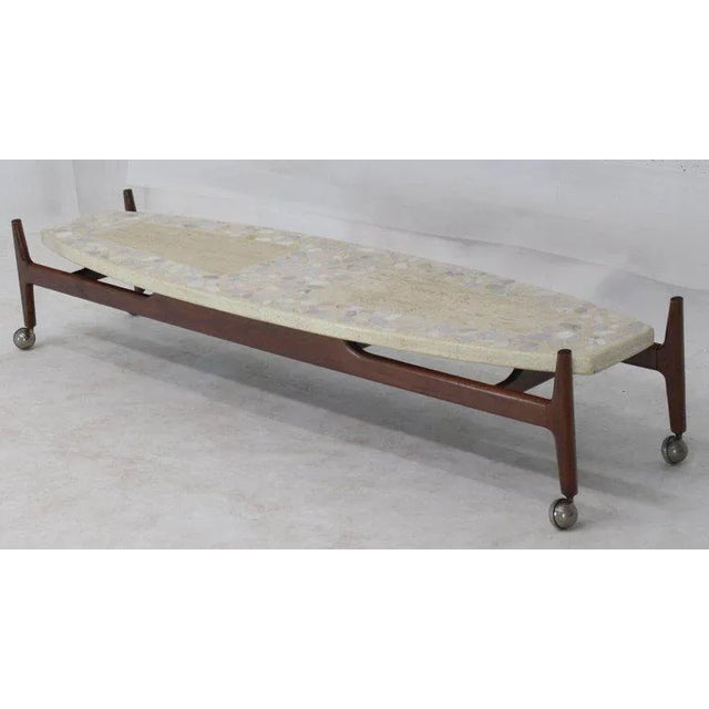 Floating terrazzo top oiled walnut base long surfboard shape coffee table. Made in the mid 20th century.