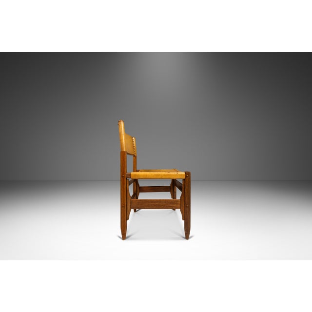 Introducing a vintage Colombian-made, tanned saddle leather & kiln dried oak and white walnut wood side chair designed by...