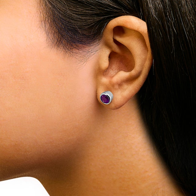 Immerse yourself in the vibrant allure of these exquisite stud earrings, each featuring a lab-created, color-treated...