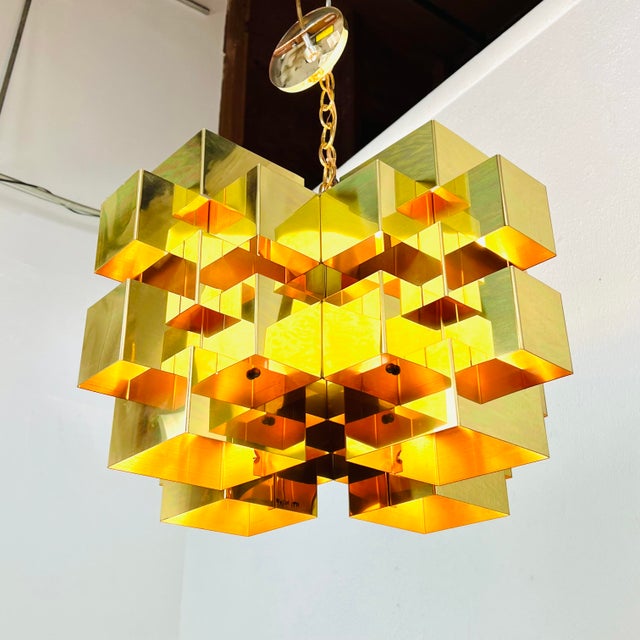 Mid Century Modern meets architectural edge in this fabulous brass cubist chandelier by Curtis Jere. Polished brass plated...