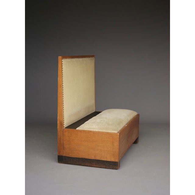 A rare Dutch oak hall bench or small occasional sofa. Executed in oak with nice black stained details on legs and behind...