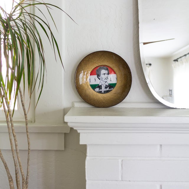 This Fornasetti-style decorative plate commemorates the 19th-century Hungarian Revolutionary and Poet Petofi Sandor...