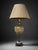 A vintage-style ornate table lamp featuring a warm gold-toned glass body, intricate decorative patterning, antique bronze-...
