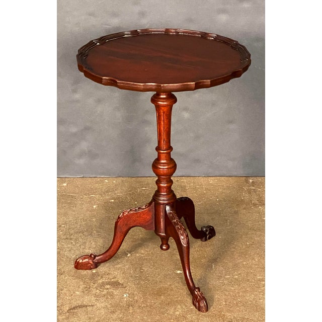 A fine English wine or cocktail table of mahogany from the Edwardian era, featuring a raised scalloped edge (or pie-crust)...