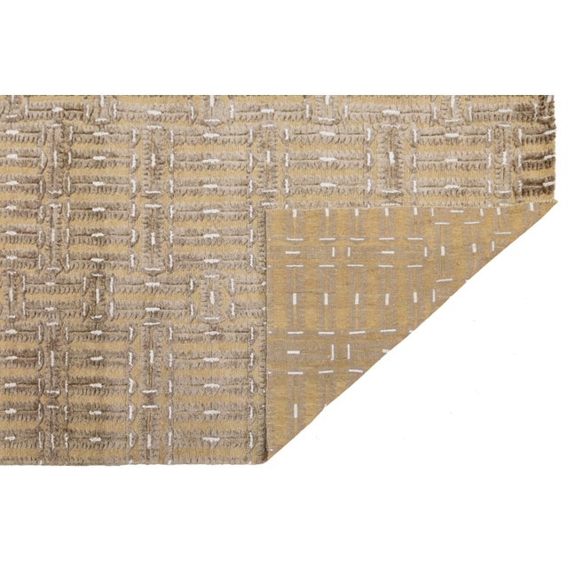 This beautiful modern Soumak hand-knotted wool rug has a tan field. It features beige accents in a gorgeous all-over...